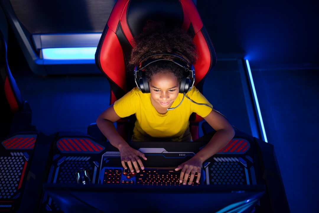 Young gamer girl playing on at a desktop PC