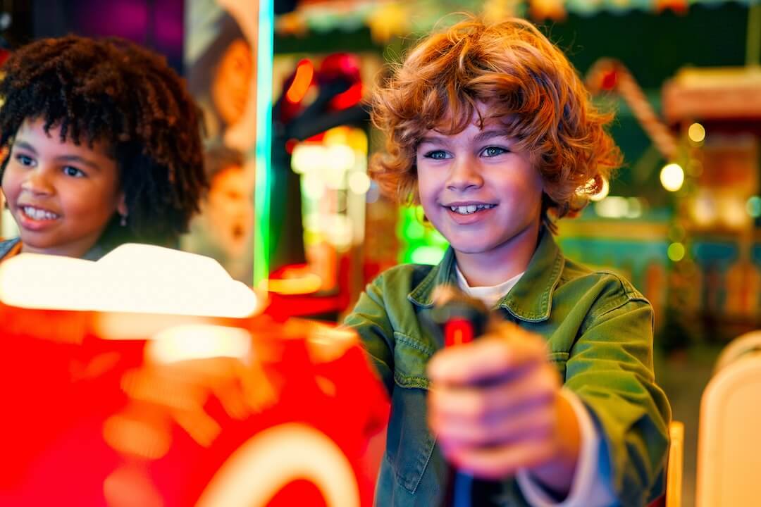 Two young boys on an arcade machine